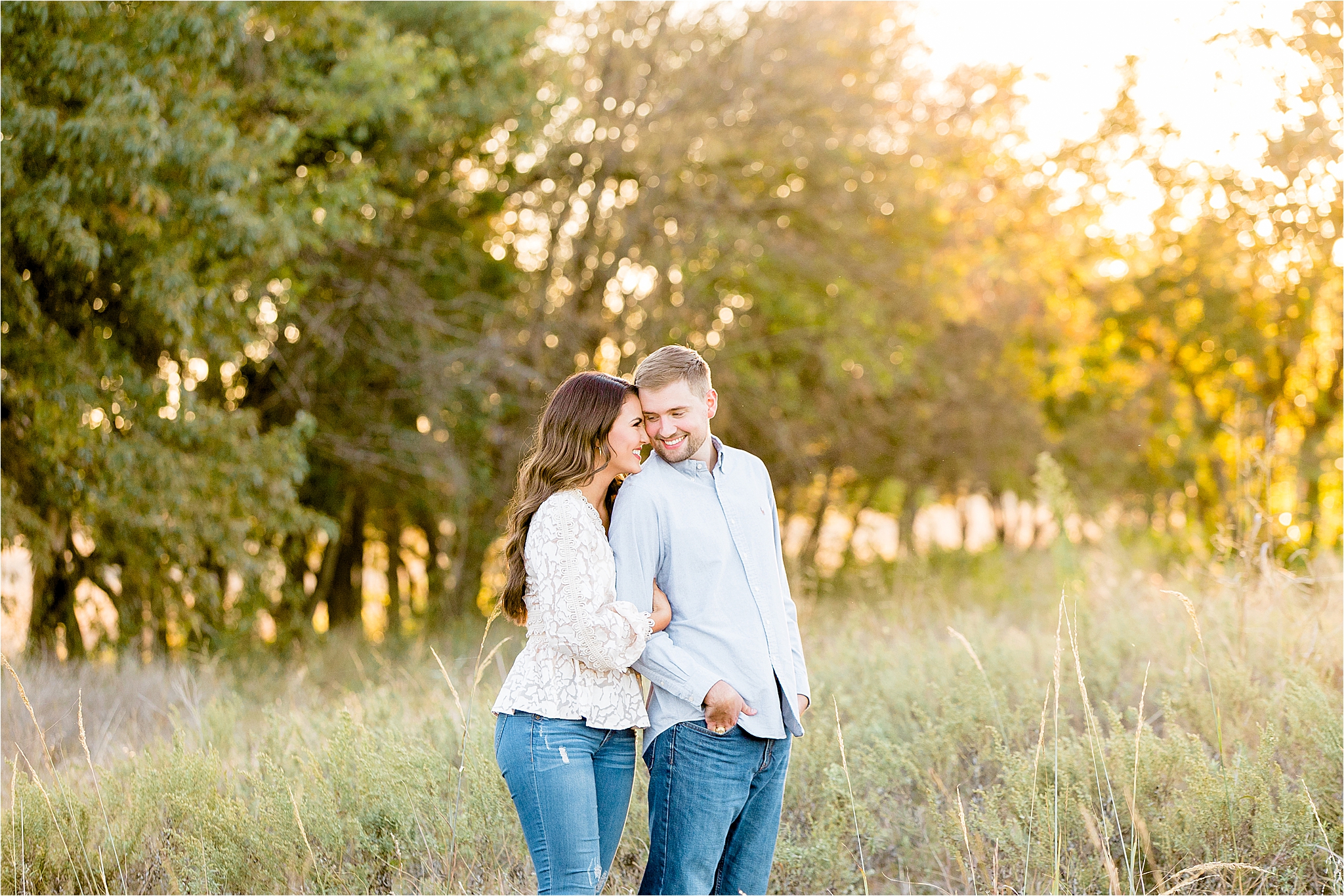 A Dallas Bride to be hugs her fiance from behind as he peeks back at her over her shoulder during their fall engagement session in McKinney, Texas 