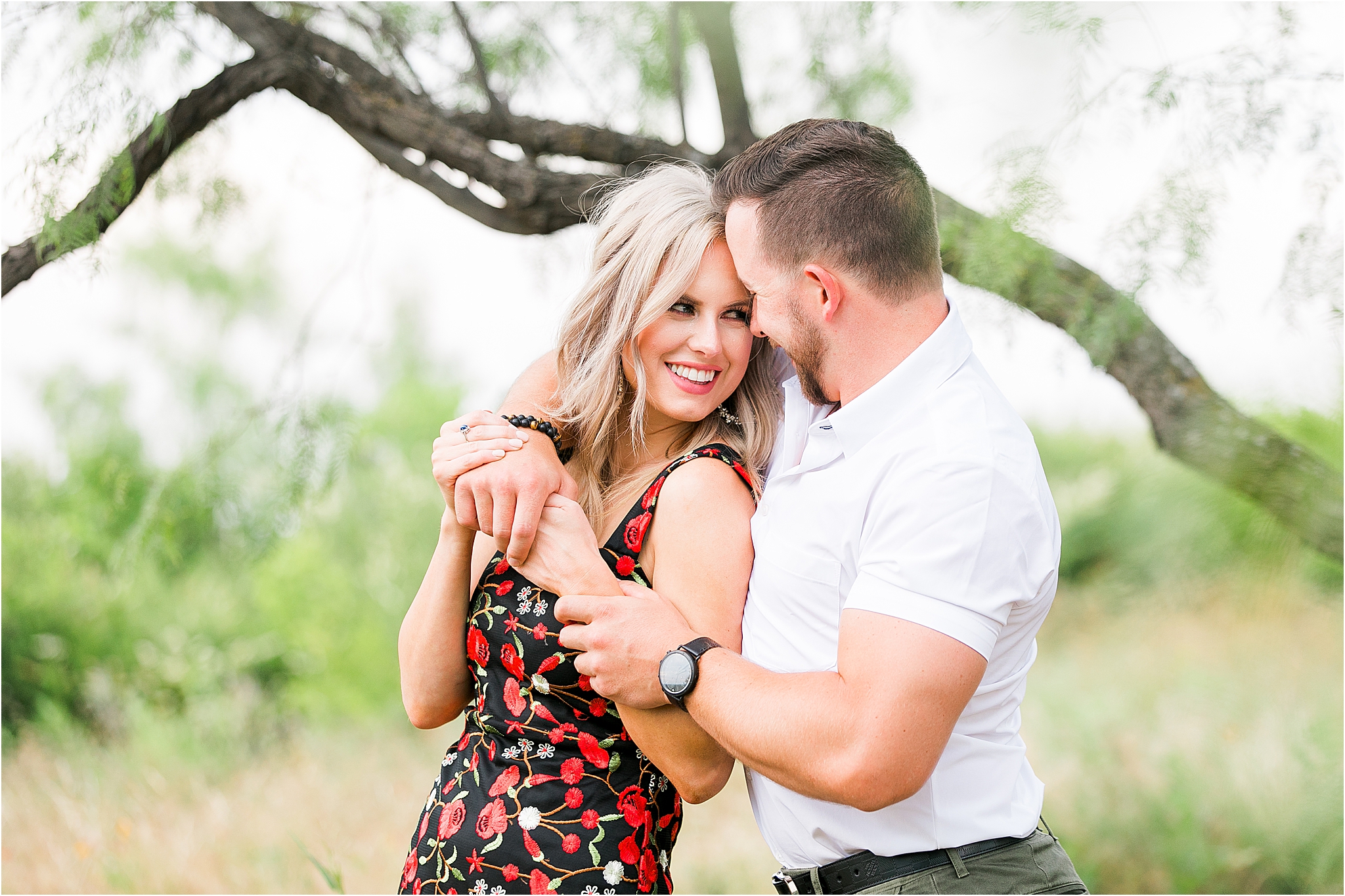 A couple embraces and looks into each other's eyes under a tree during their fort worth engagement session 