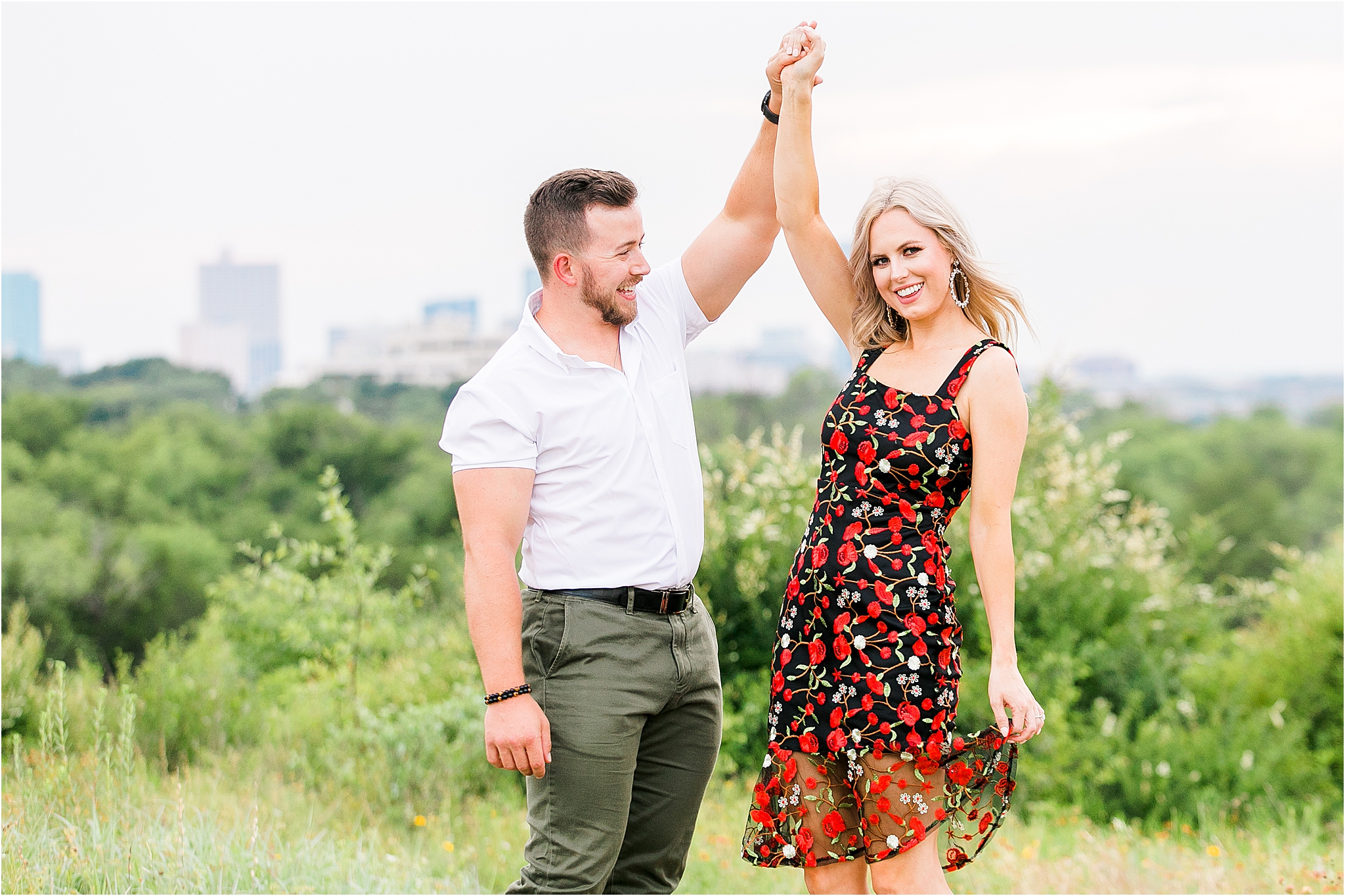 A beautiful bride to be twirls in a dress with her fiance and looks the camera during her Tandy Hills Engagement Session in Fort Worth, Texas 