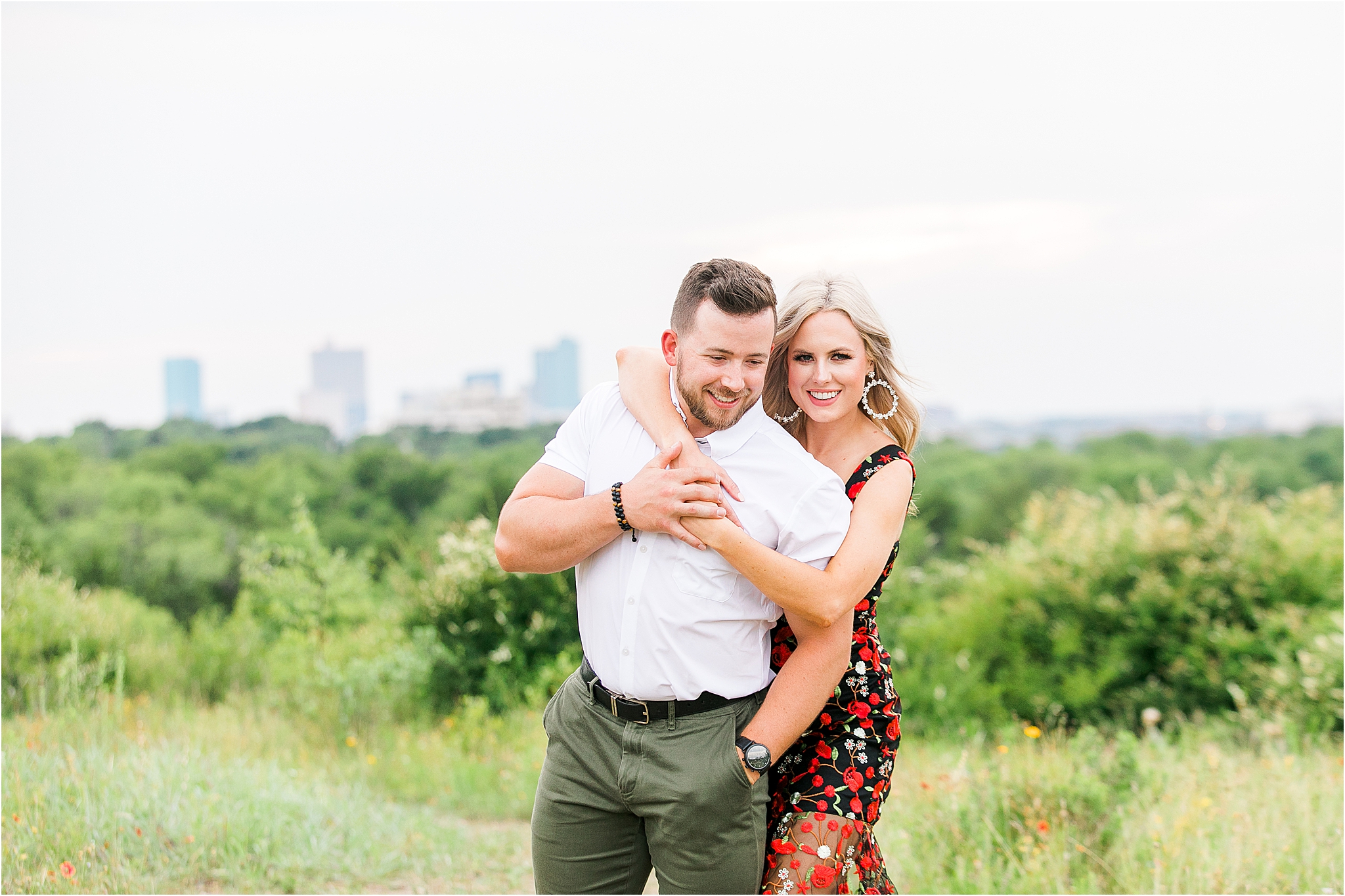 A couple embraces hugging during their engagement session at Tandy Hills Nature Preserve during their Fort Worth Engagement 