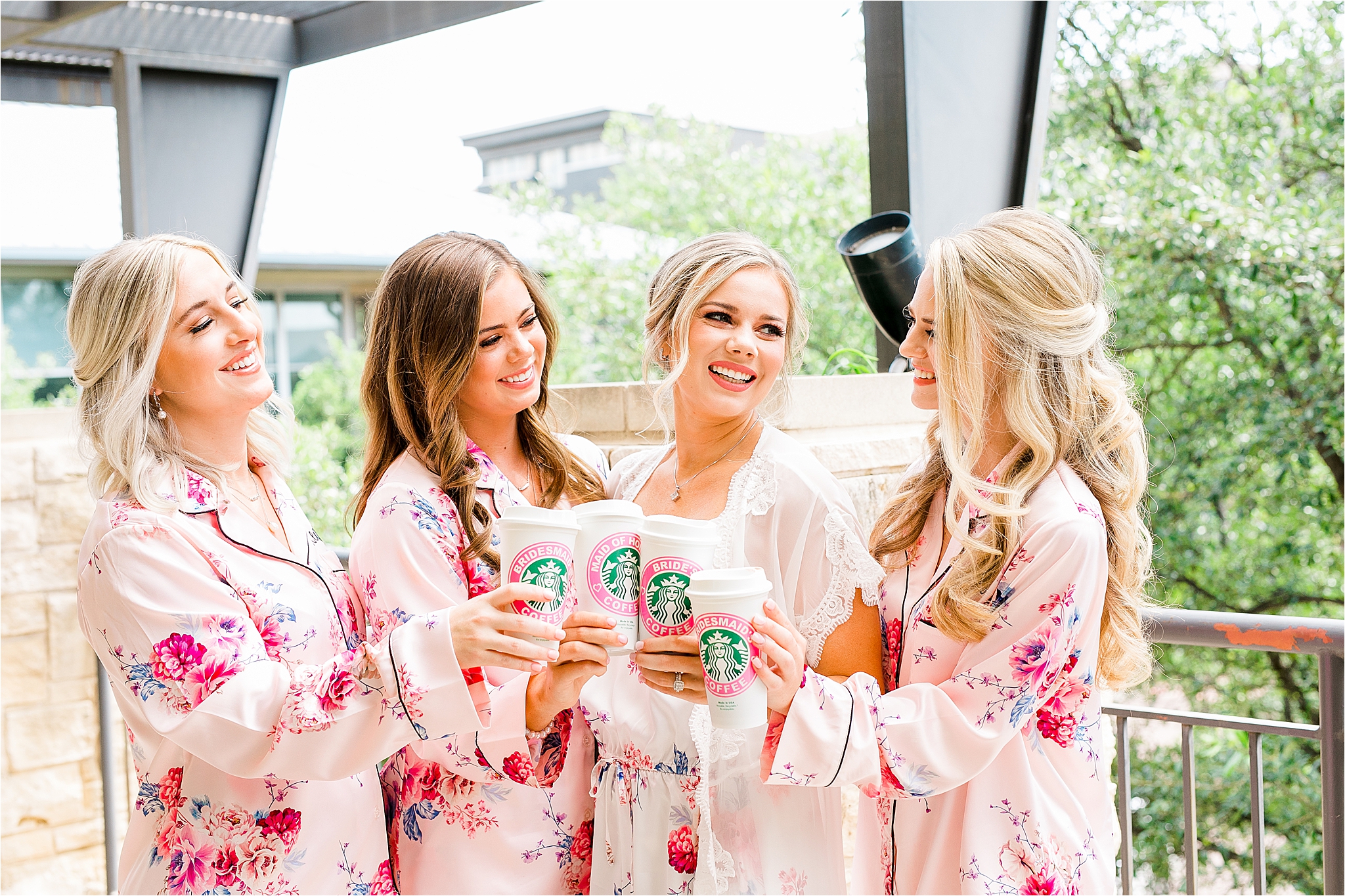 A bride and her bridesmaids cheers with their custom wedding starbucks cups perfect for wedding gifts at classic dallas wedding 