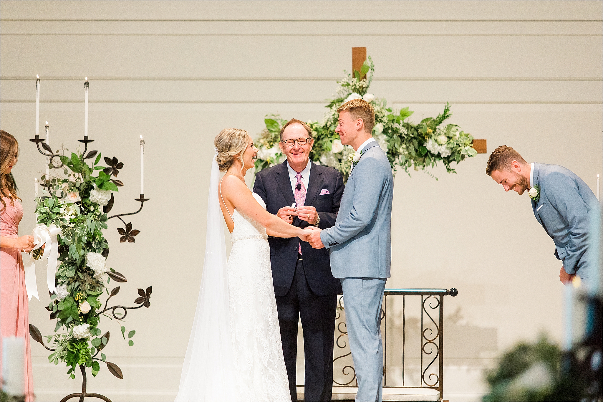 A bride and groom laugh as they exchange wedding vows during their Dallas Wedding Ceremony at Prestonwood Chapel by DFW Wedding Photographer Jillian Hogan 