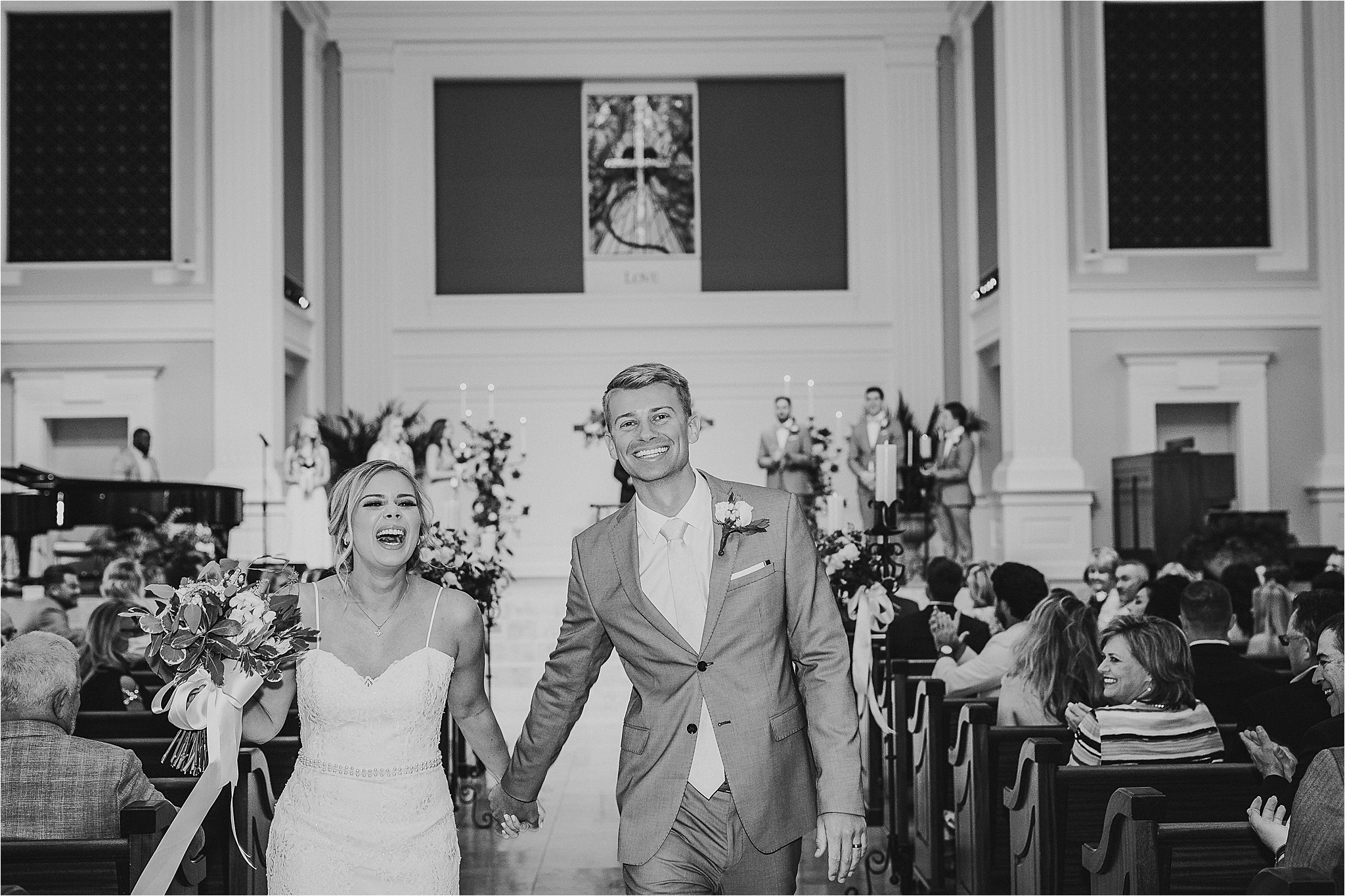 A joyous couple walks down the aisle after being announced as husband and wife at their classic dallas wedding ceremony 