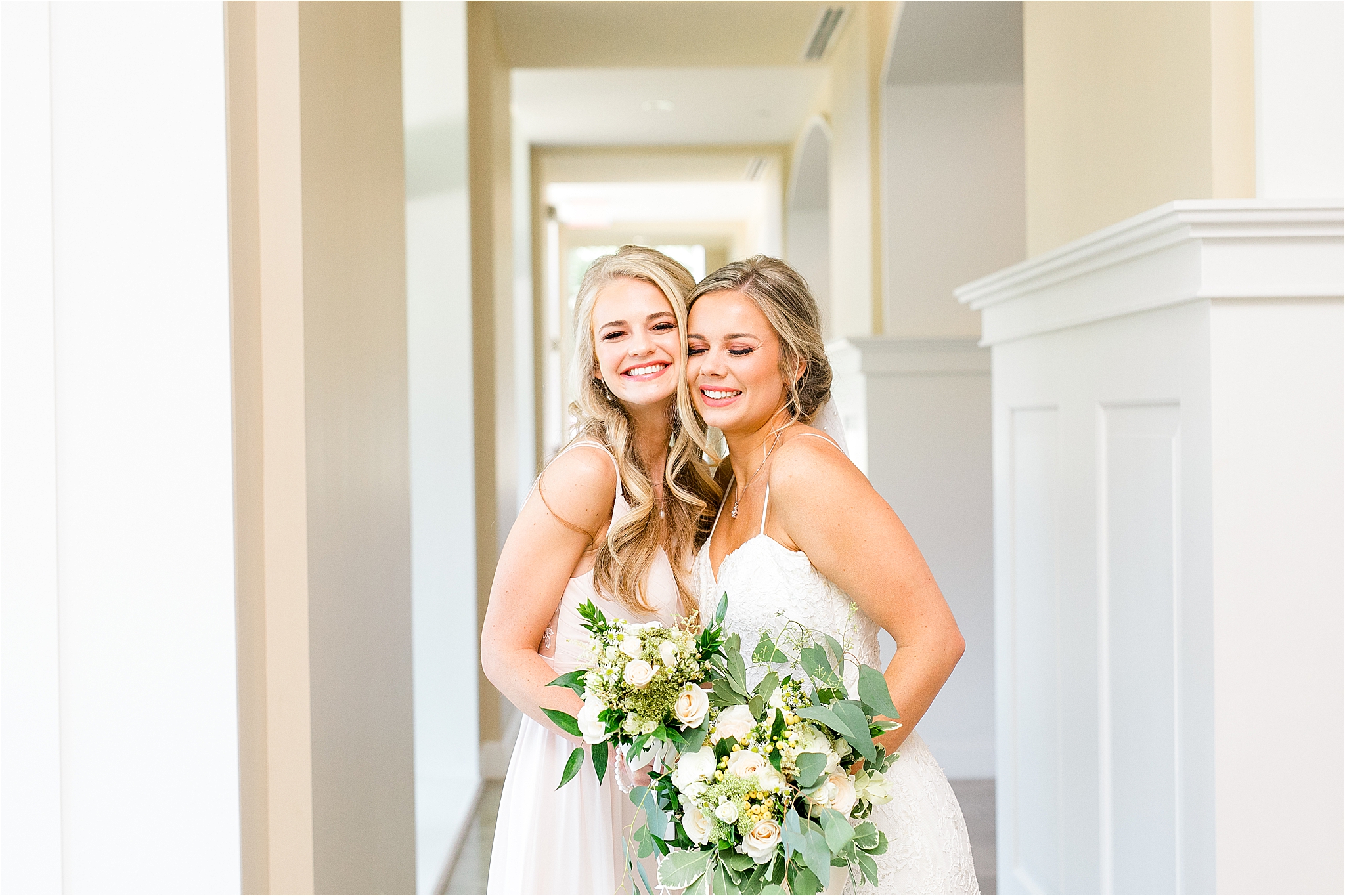 A beautiful bride and her bridesmaid share a big hug during bridal party portraits by Dallas Wedding Photographer Jillian Hogan 