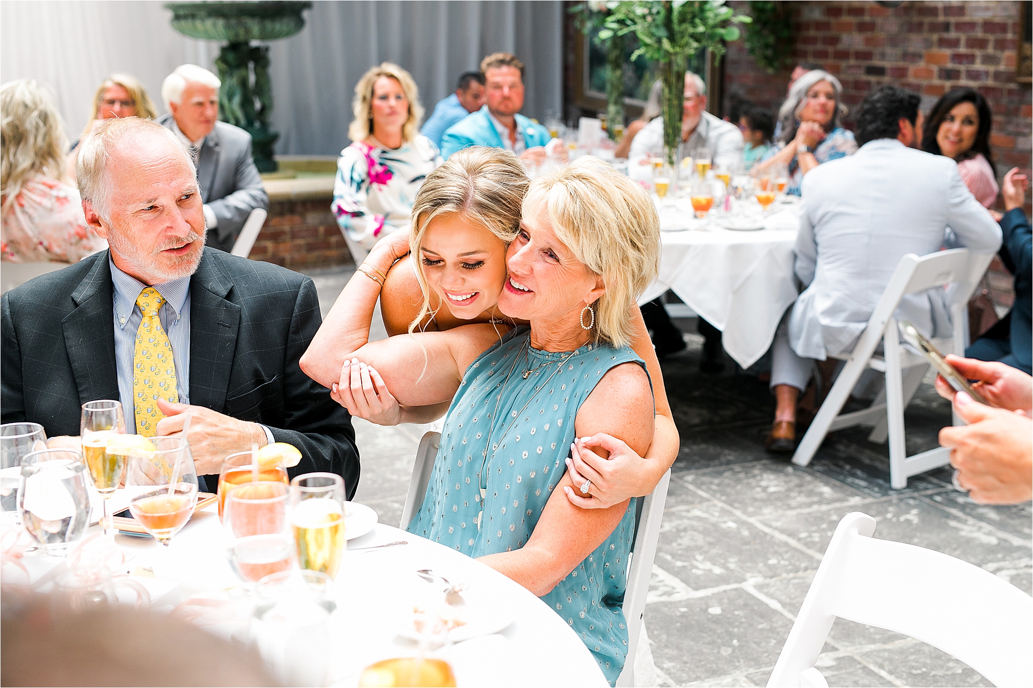 A bride hugs a guest tight at her classic III Forks Wedding Reception in Dallas, Texas 