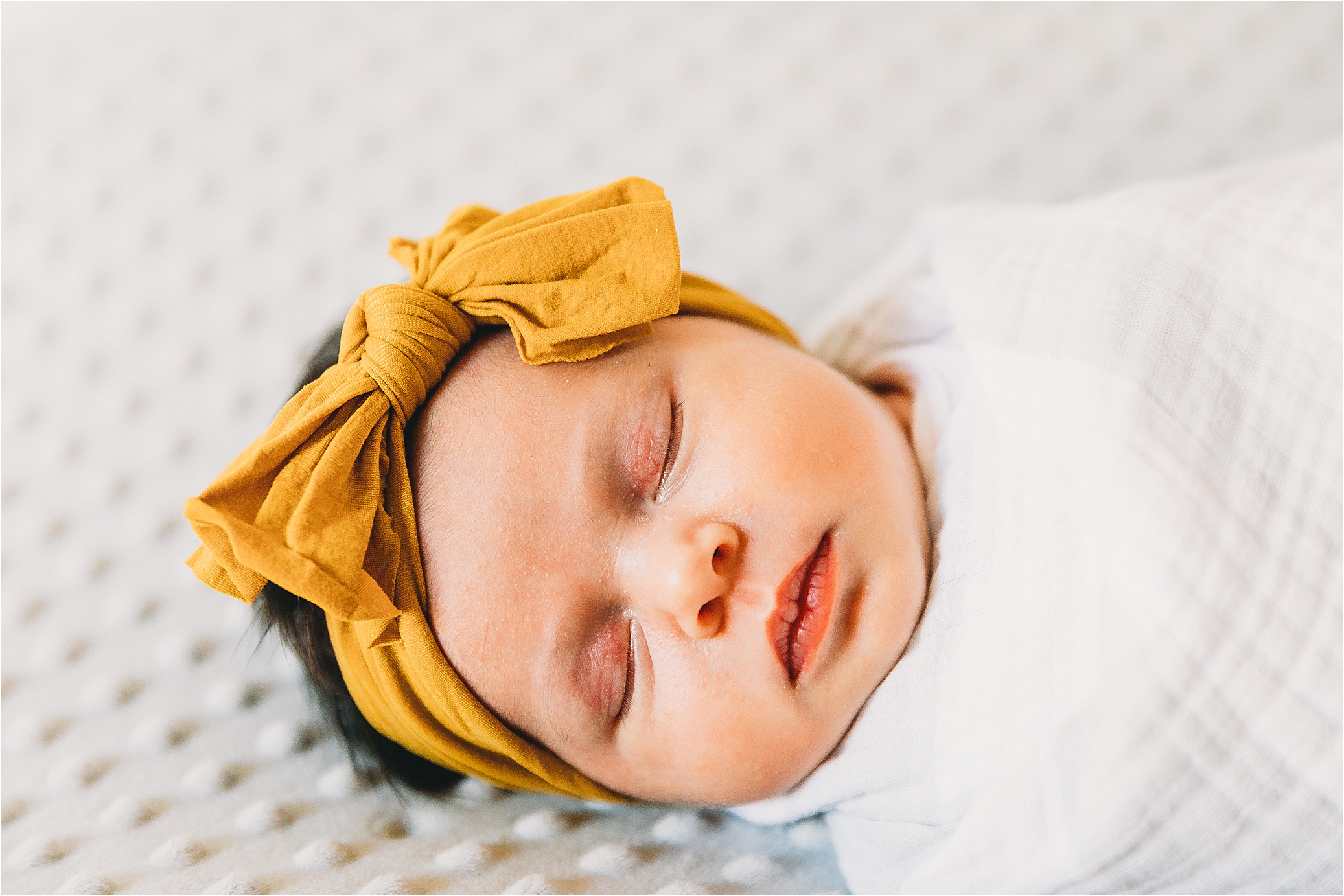 Baby girl in an adorable mustard headband during a mckinney lifestyle newborn session 