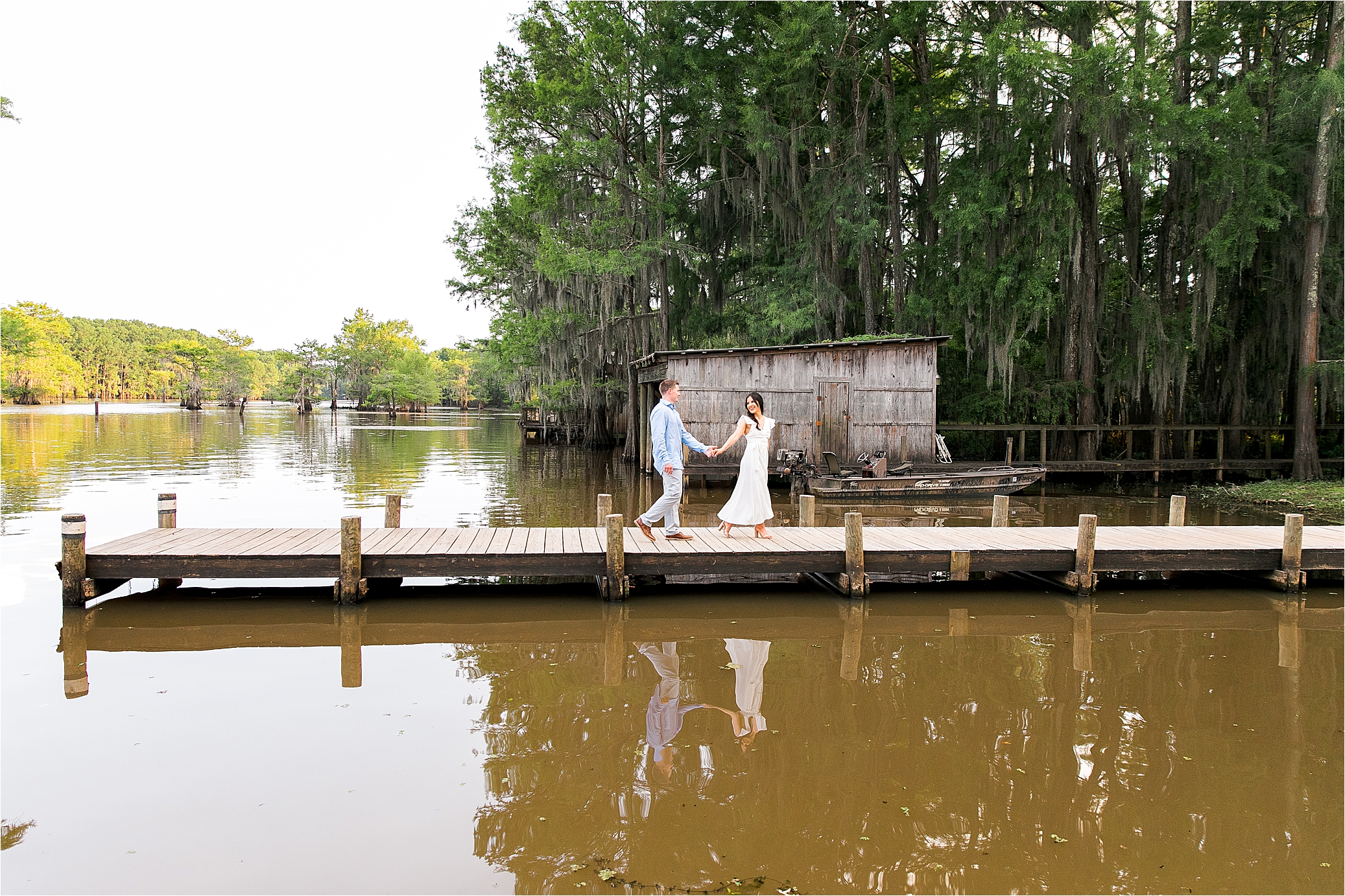 A bride to be playfully pulls along her groom at their Caddo Lake Engagement Session in East Texas 