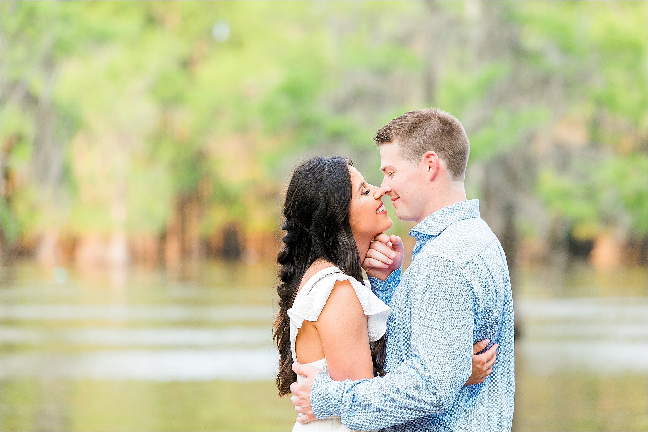 A couple embraces during their east texas engagement session at Caddo Lake 