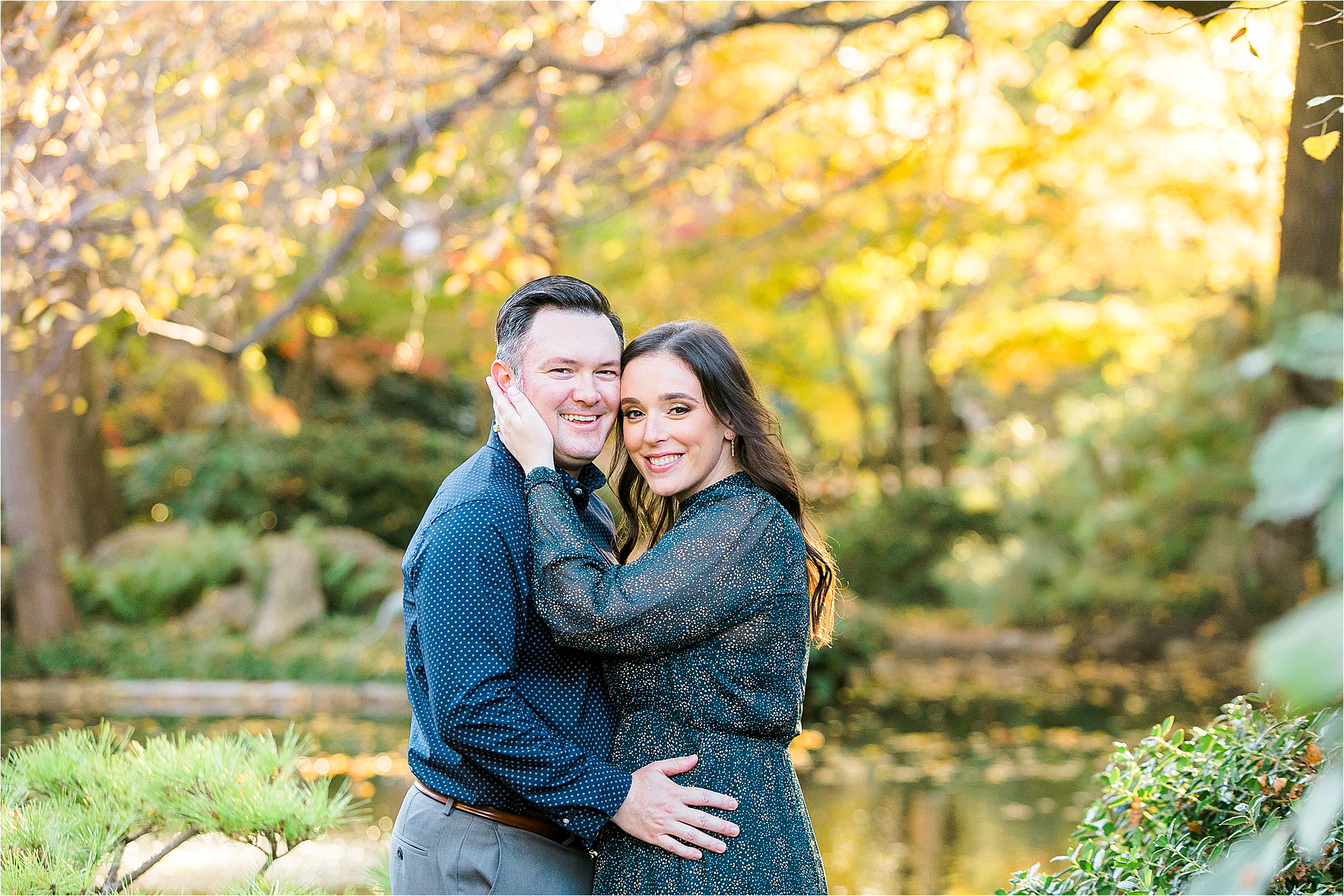 A couple hugs and smiles at the camera during their DFW Engagement Session at The Fort Worth Japanese Gardens 