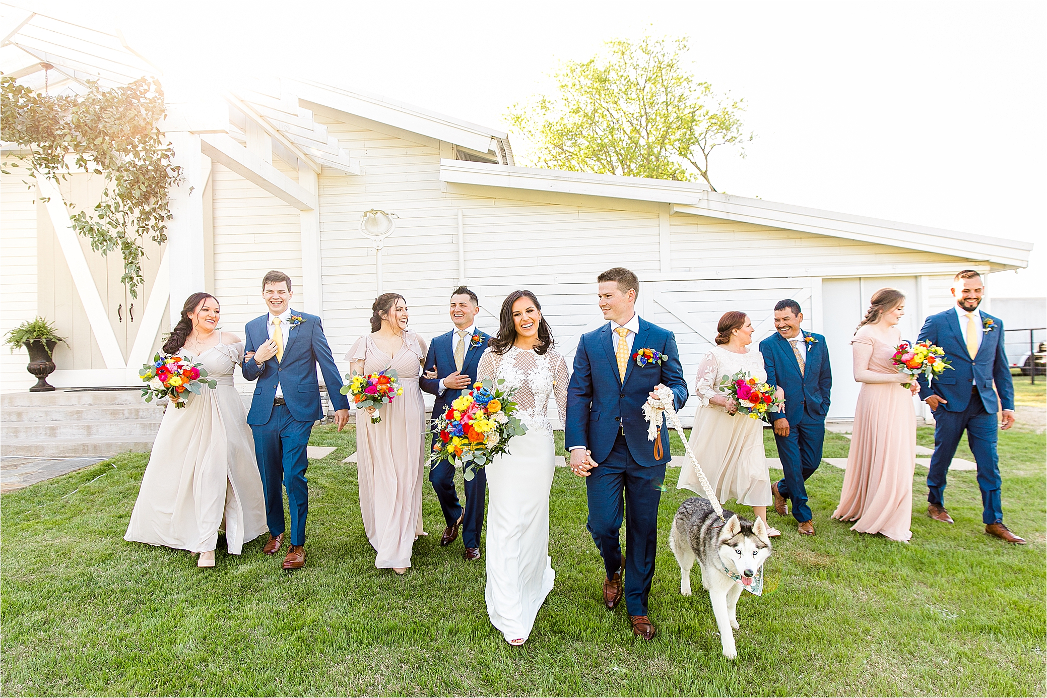 A bridal party with their dog in tow walk toward the camera during wedding day portraits at PIneway Farms with Hill Country Wedding Photographer Jillian Hogan 