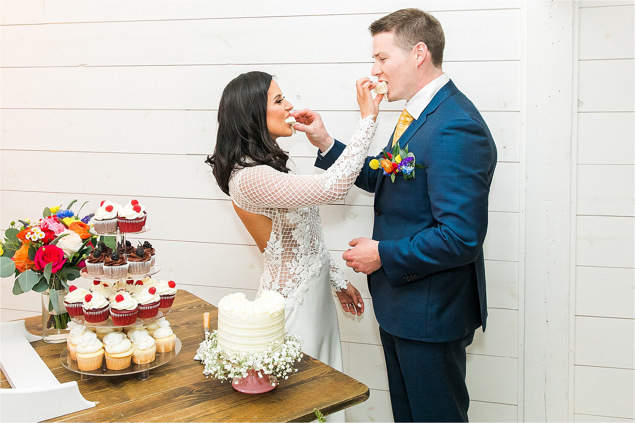 A just married couple feeds each other cake on their wedding day at Pineway Farms in East Texas