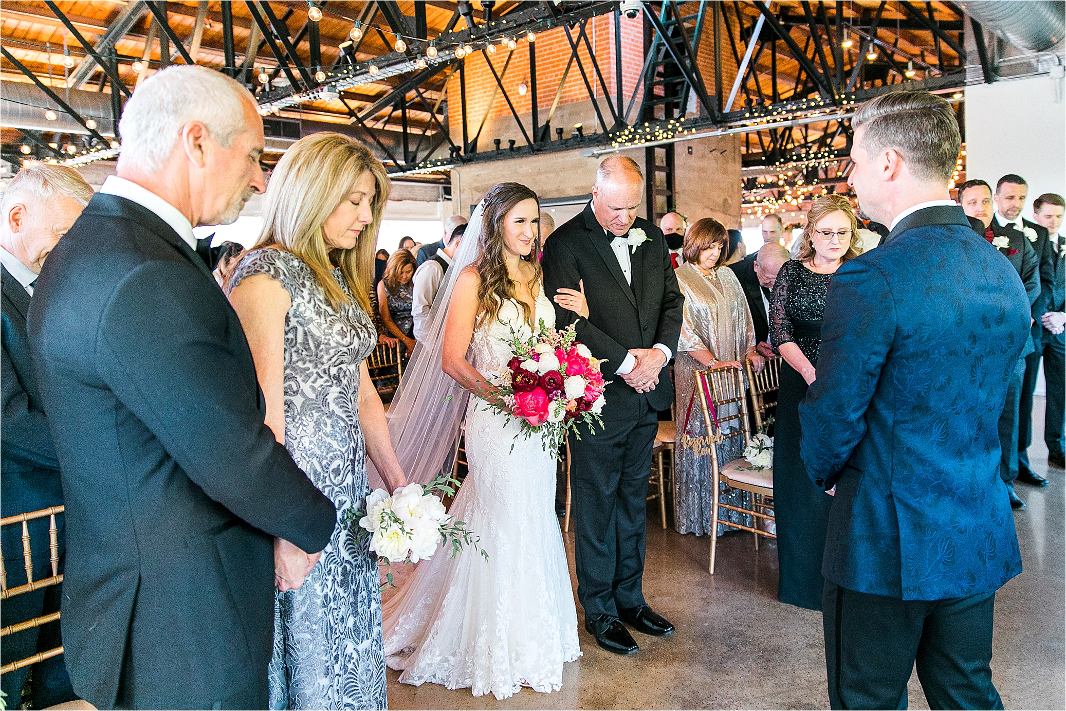 A bride smiles as she meets her groom at the front of the aisle during their wedding ceremony at Hickory Street Annex in Dallas, TX with Wedding Photographer Jillian Hogan 