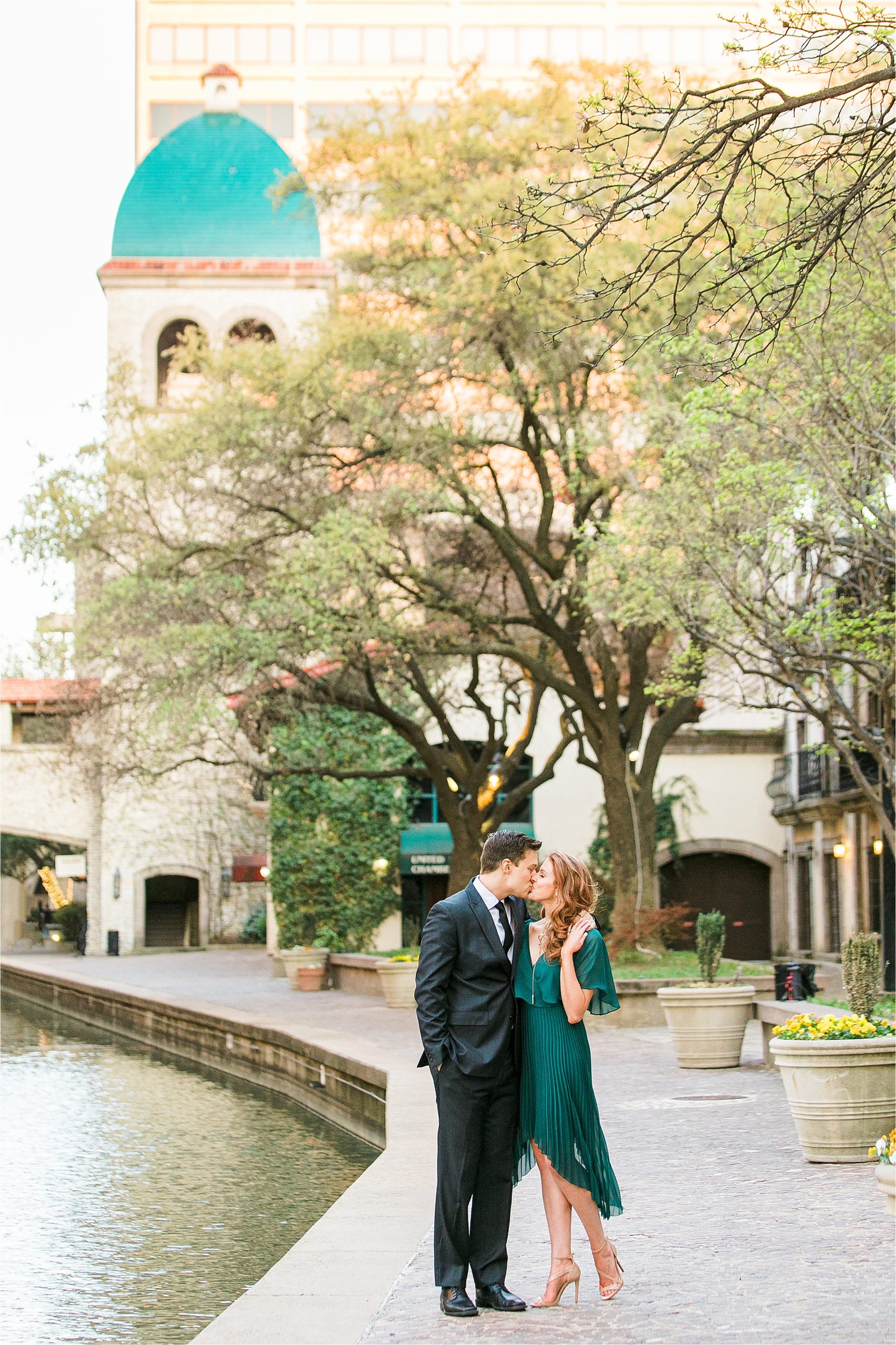 An engaged couple shares one last kiss along the canals during their riverwalk inspired engagement session with San Antonio Wedding Photographer Jillian Hogan Photography 