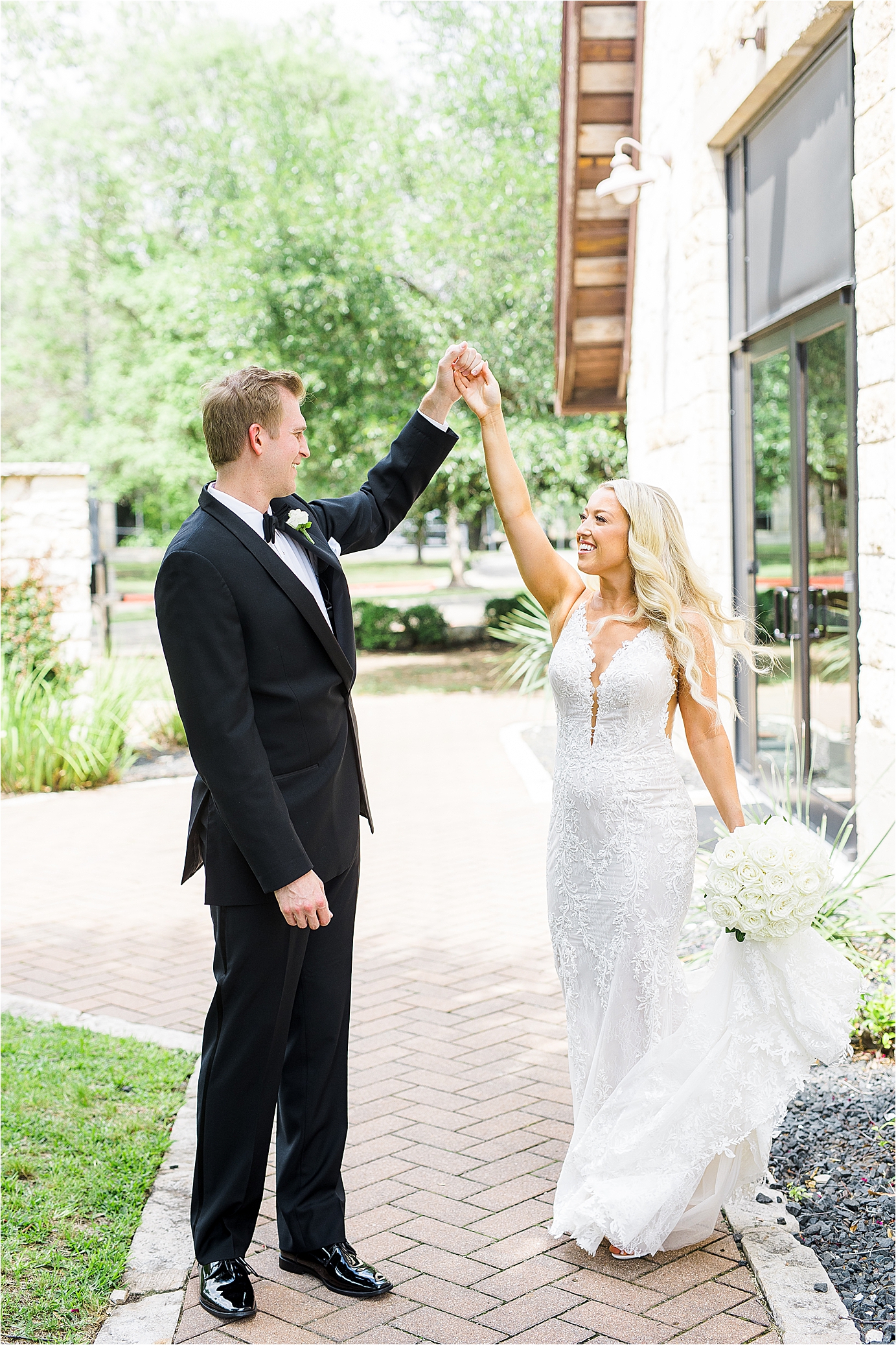 A bride and groom dance outside of their Brodie Homestead Wedding in Austin, Texas surrounded by greenery. 