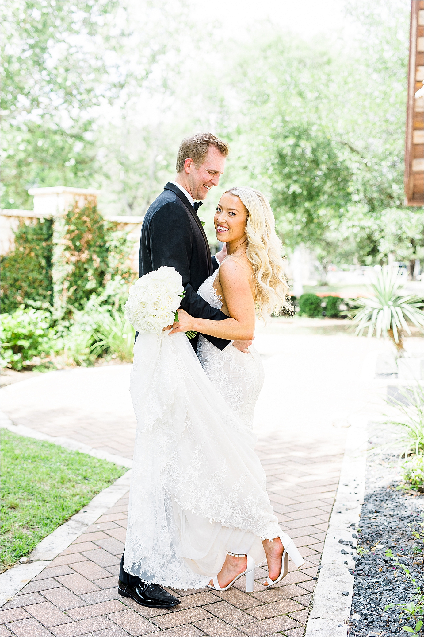 A bride and groom share big smiles as the bride looks back at the camera on their Brodie Homestead Wedding day with Austin Wedding Photographer Jillian Hogan 