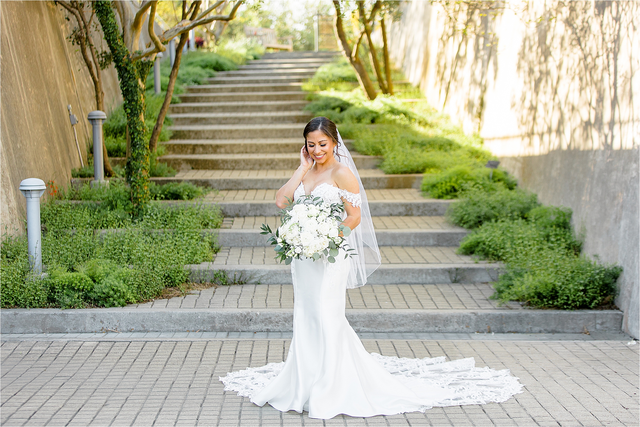 A bride smiles during her bridal portraits at San Antonio Botanical Garden 