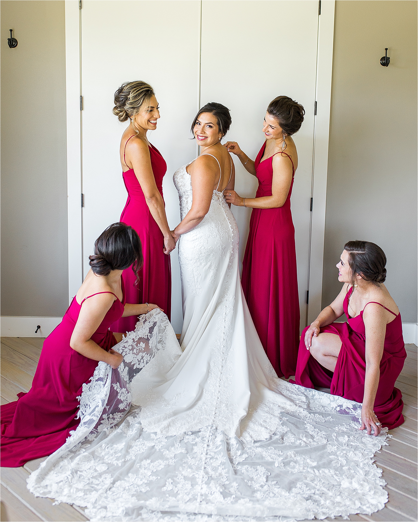 A bride peeks back over her shoulder as her bridesmaids help her get married at Paniolo Ranch in Boerne, Texas