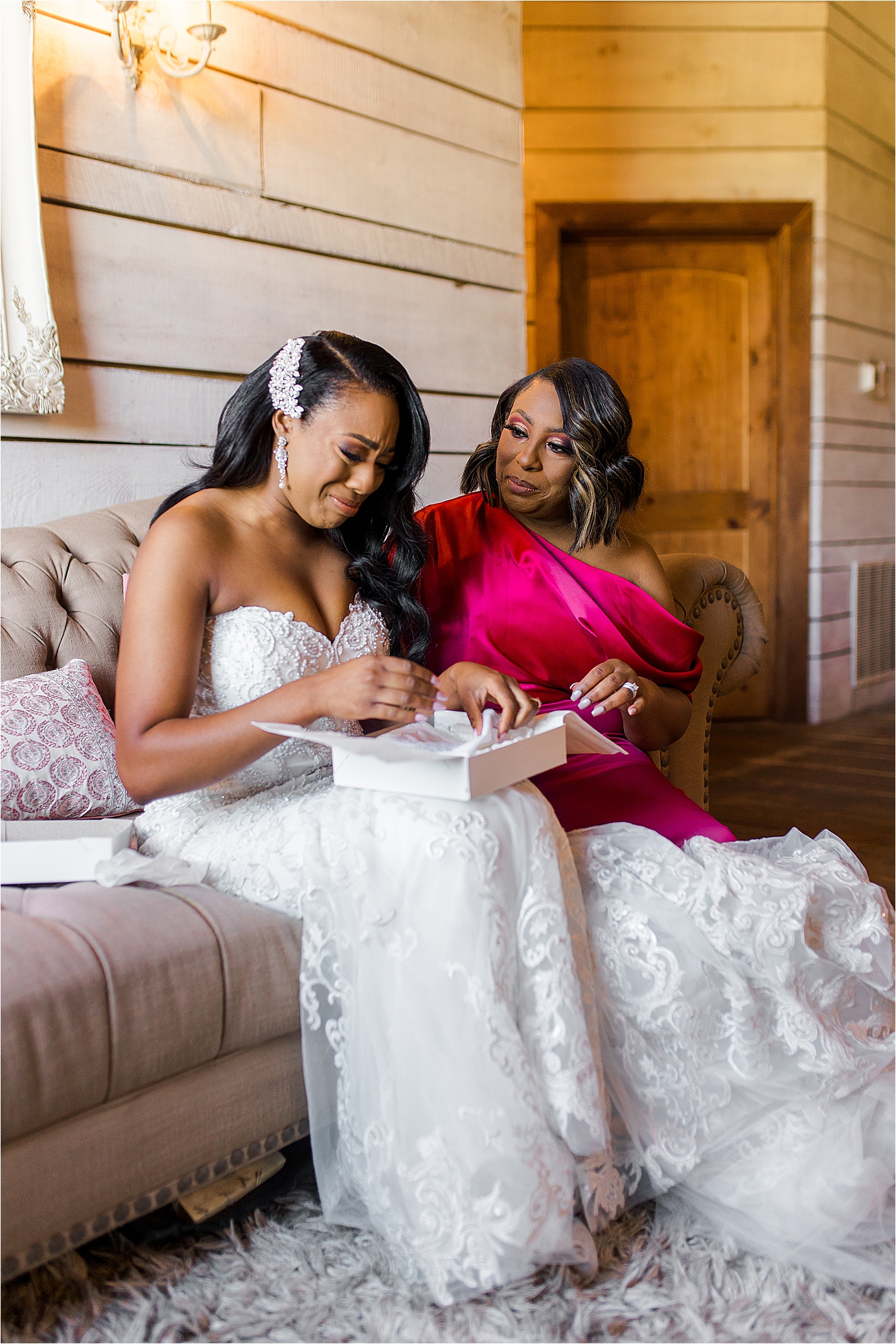 A bride cries as she opens a gift from her mom at the morgan creek barn by Boerne Wedding Photographer Jillian Hogan 