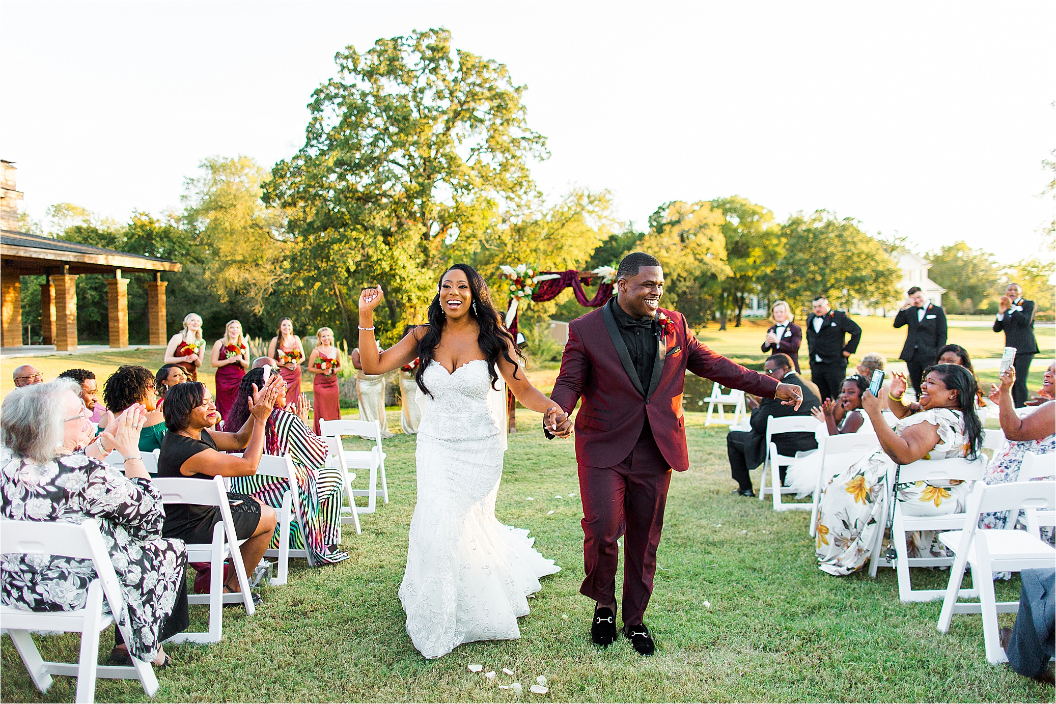 A bride and groom cheer as they walk down the aisle as husband and wife at Morgan Creek Barn 