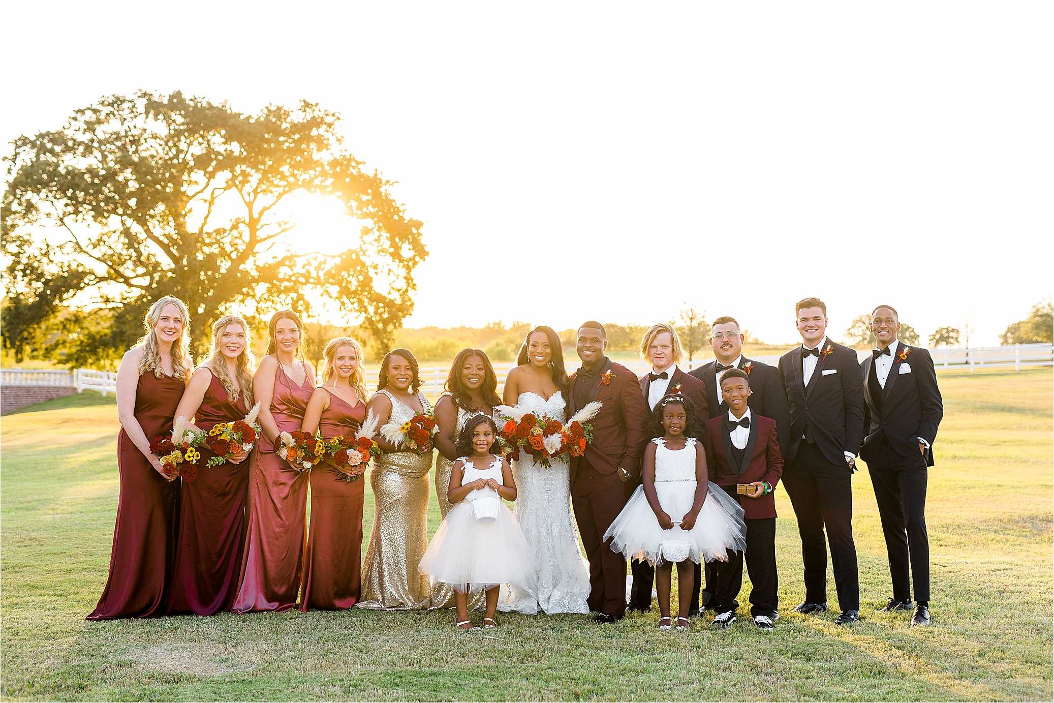 A full wedding party with the sunset behind them at The Milestone by Boerne Wedding Photographer Jillian Hogan 