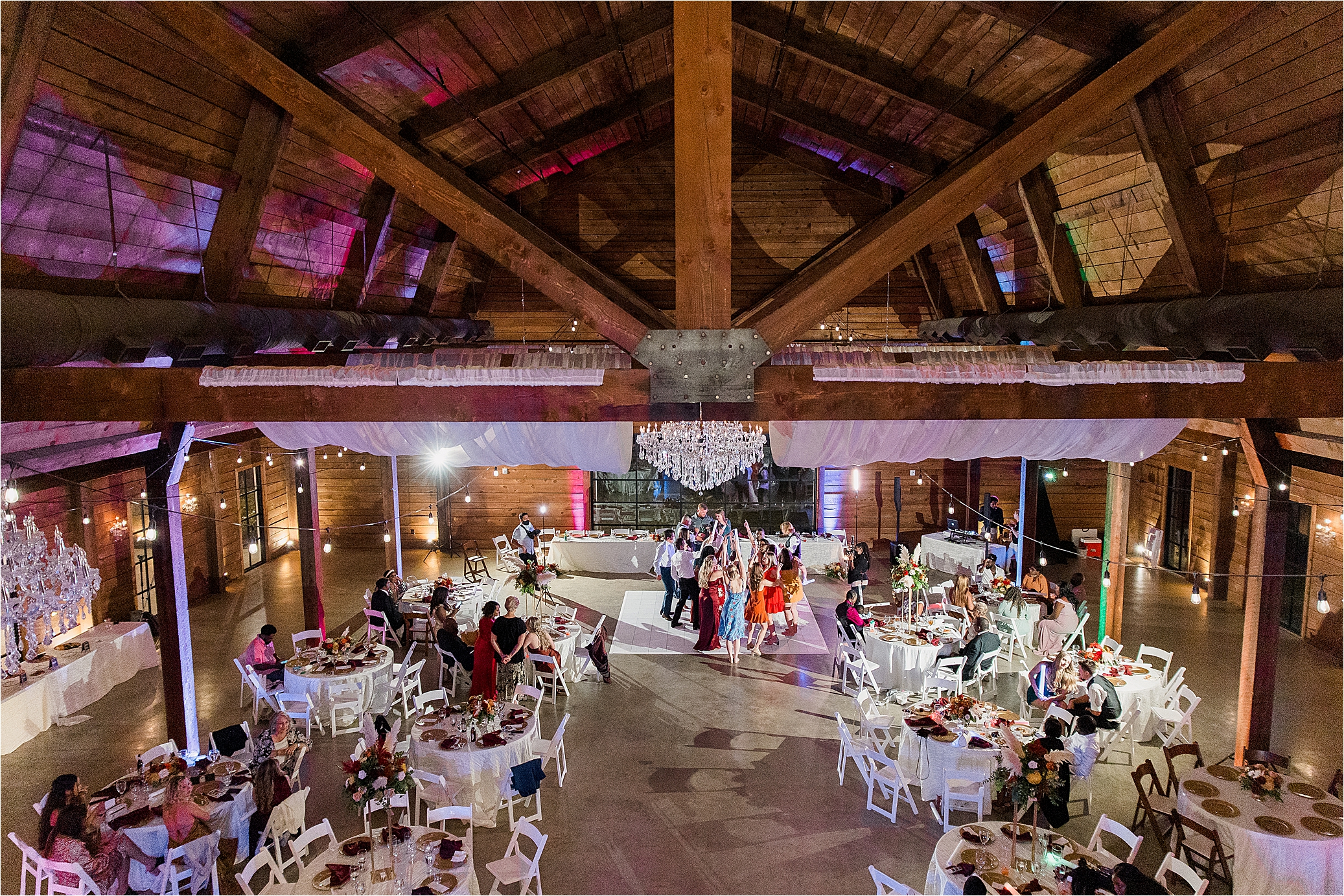 Guests dance at Morgan Creek Barn, a walter's wedding estate venue, in Dallas Area by Wedding Photographer Jillian Hogan 