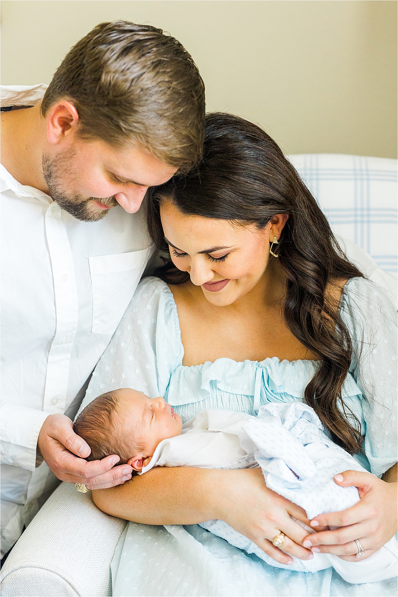 New parents admire and cradle their newborn baby boy during lifestyle newborn photos in San Antonio, Texas
