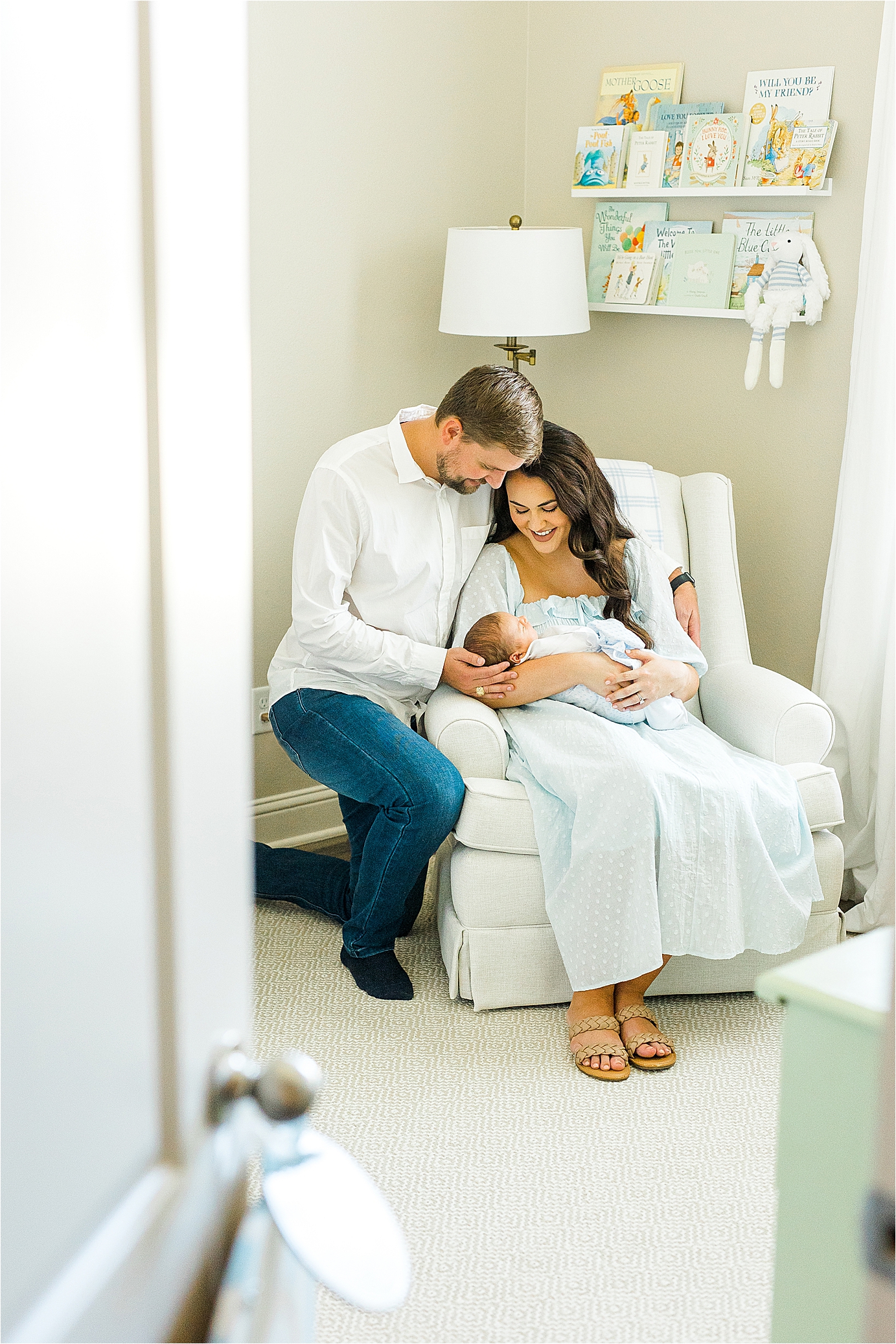 A couple snuggles their newborn baby boy in the corner of a beautiful nursery with San Antonio Newborn Photographer Jillian Hogan 