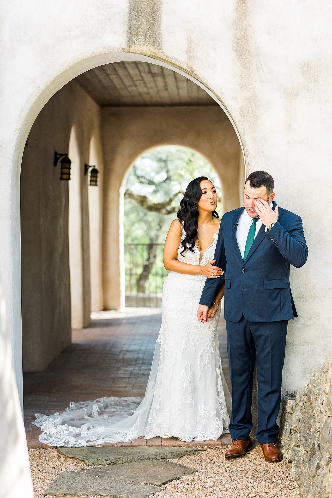 A bride and groom share a first touch before walking down the aisle at Lost Mission, a wedding venue in The Texas Hill Country