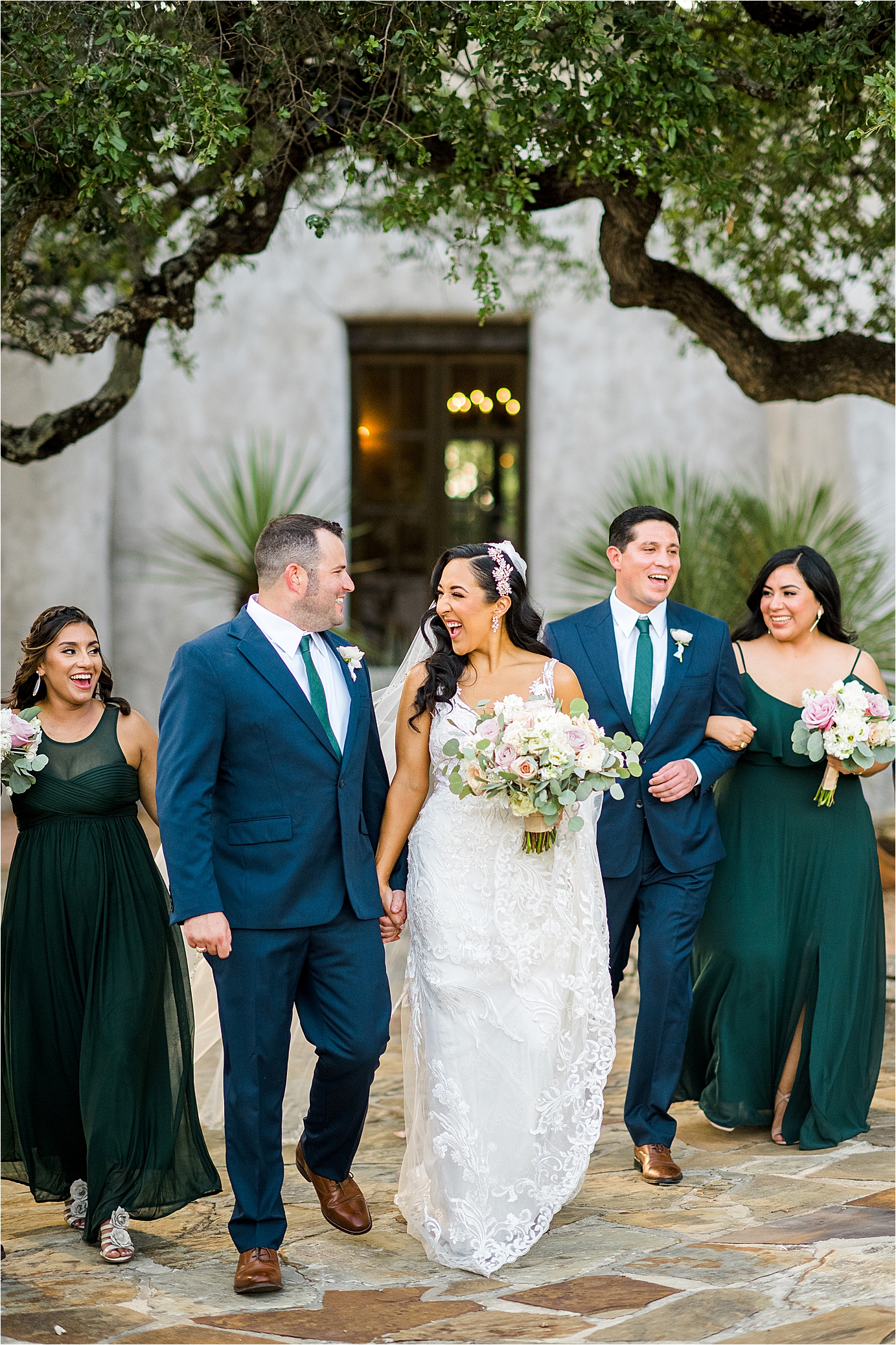 A bride and groom celebrate with their bridal party during portraits at Lost Mission in The Texas Hill Country 