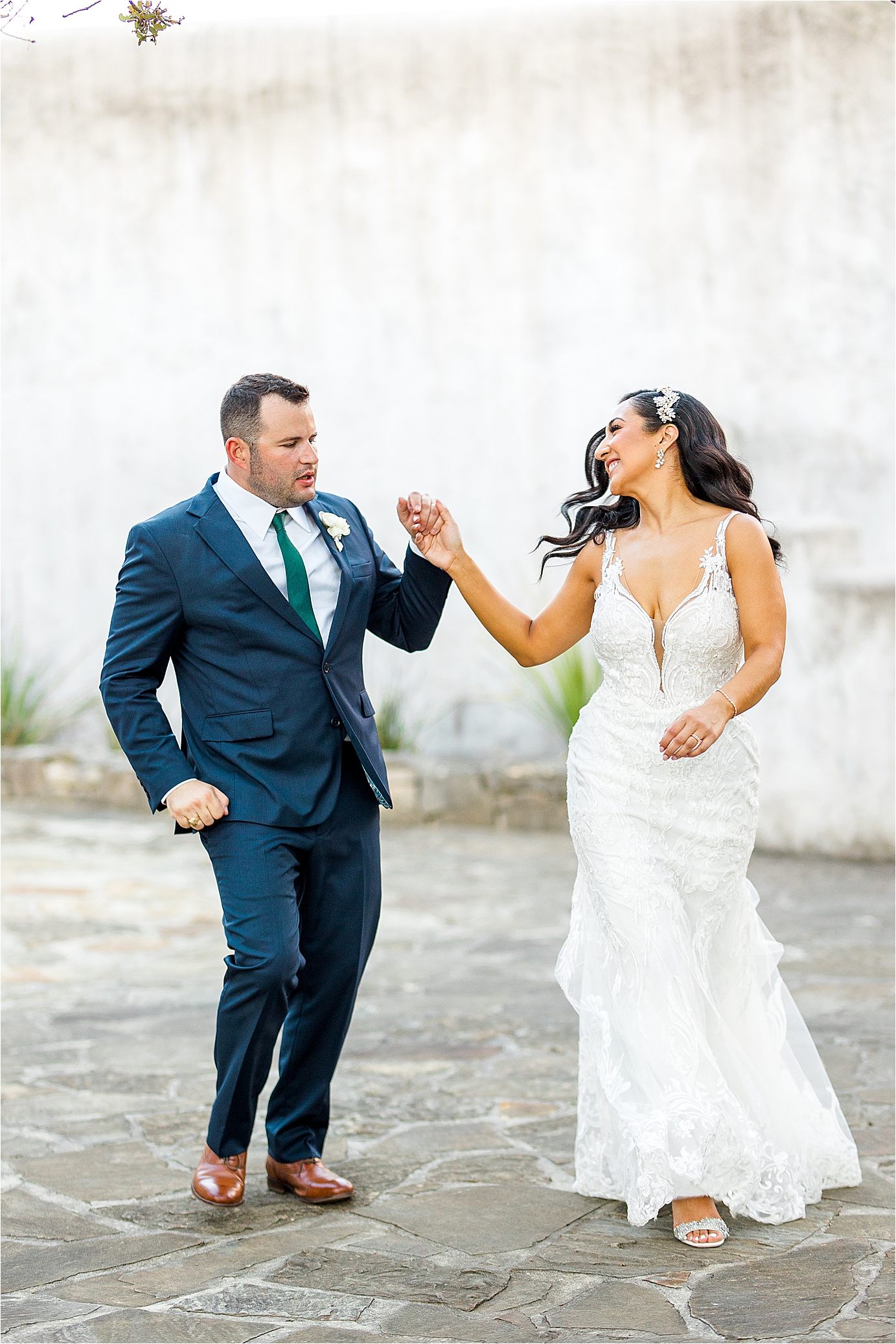 A bride dances with her husband as they head to wedding reception at Lost Mission with San Antonio Wedding Photographer Jillian Hogan Photography 