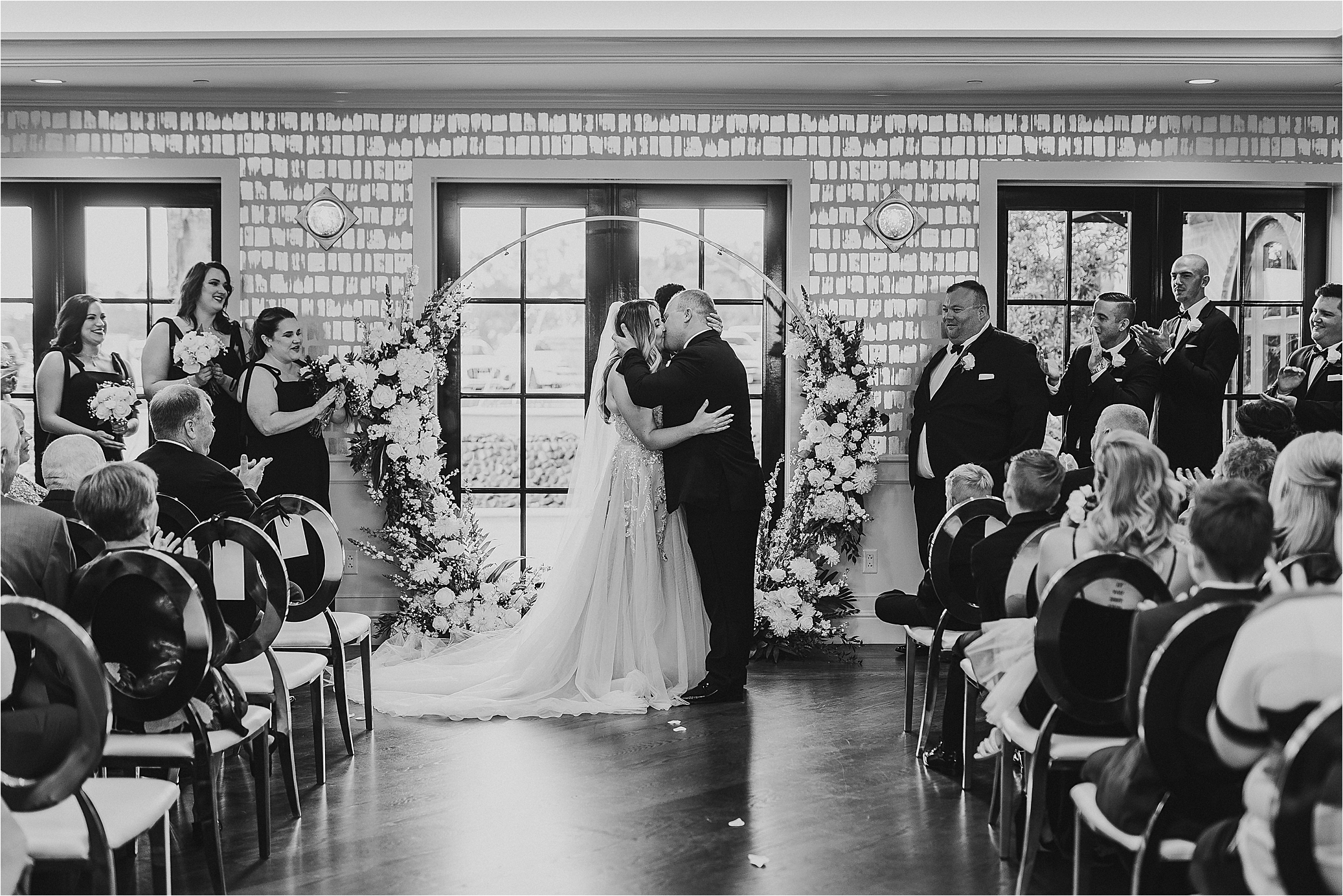 A bride and groom share their first kiss as husband and wife at The Redberry Estate in San Antonio, Texas 