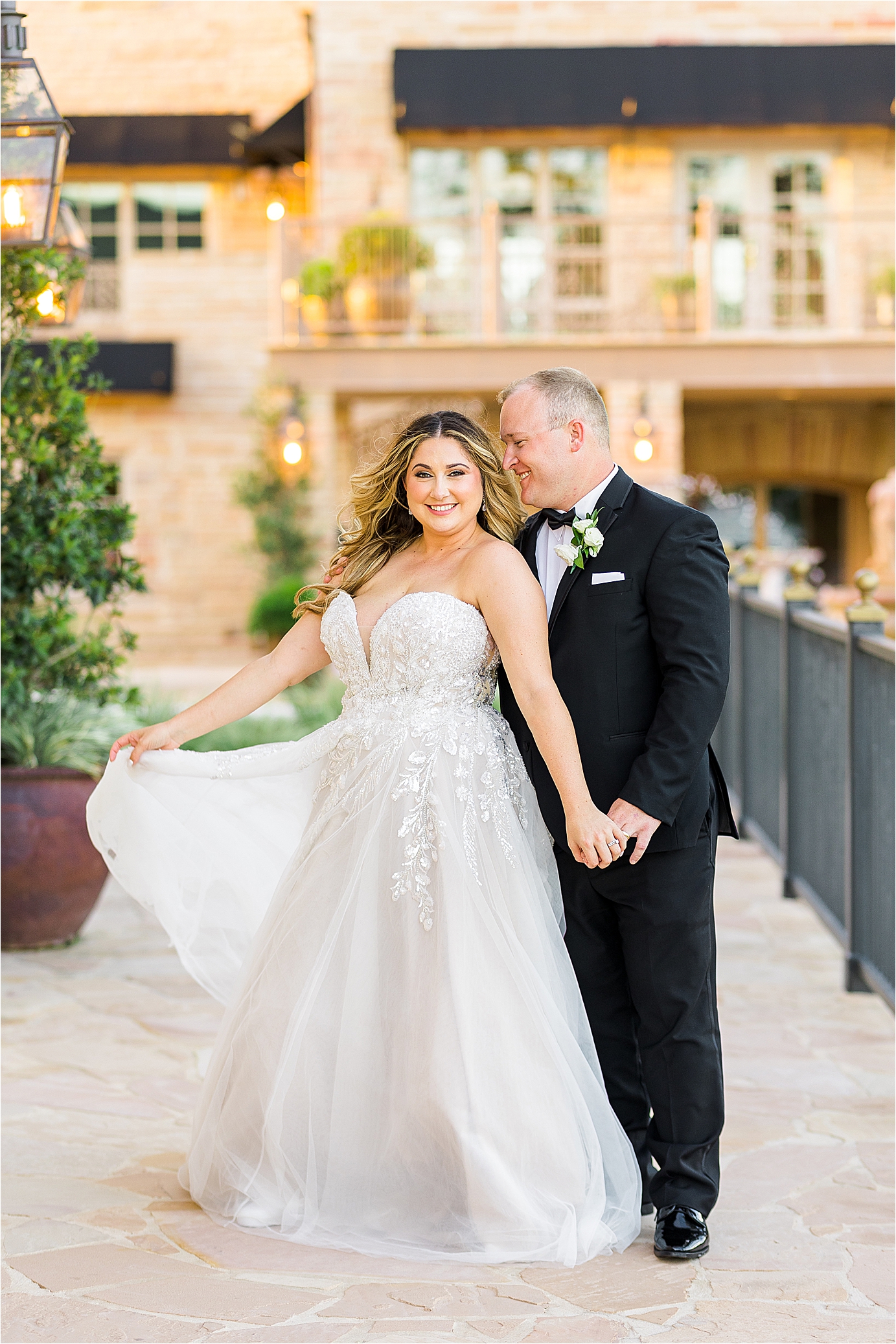 A bride and groom pose in front of the redberry estate during sunset couple portraits in San Antonio, Texas with wedding photographer Jillian Hogan 