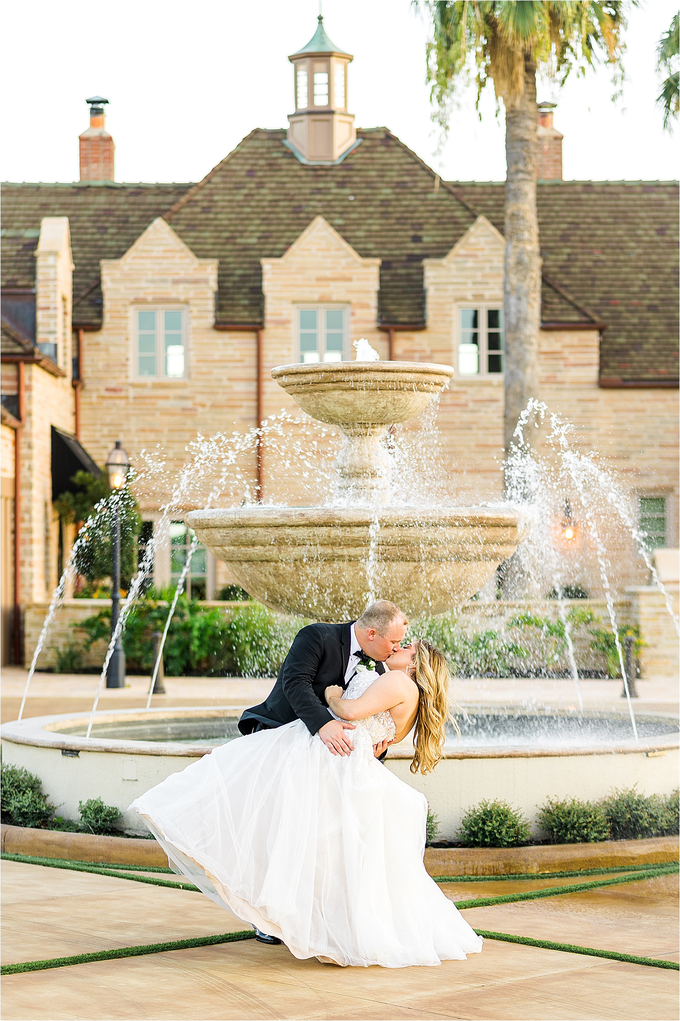 A just married couple kisses in front of the fountain at The Redberry Estate in San Antonio, Texas 