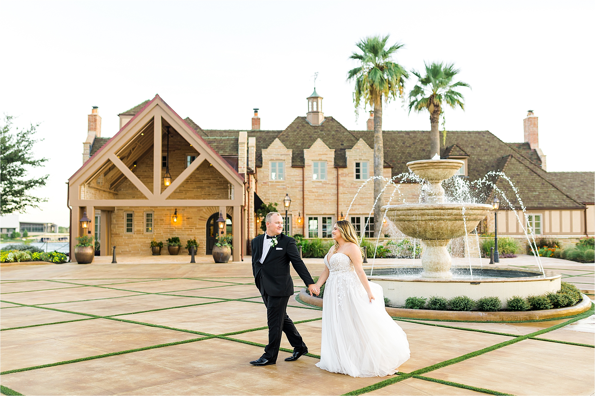 A newlywed couple walks hand in hand in front of the Redberry Estate in San Antonio, Texas by San Antonio Wedding Photographer Jillian Hogan 
