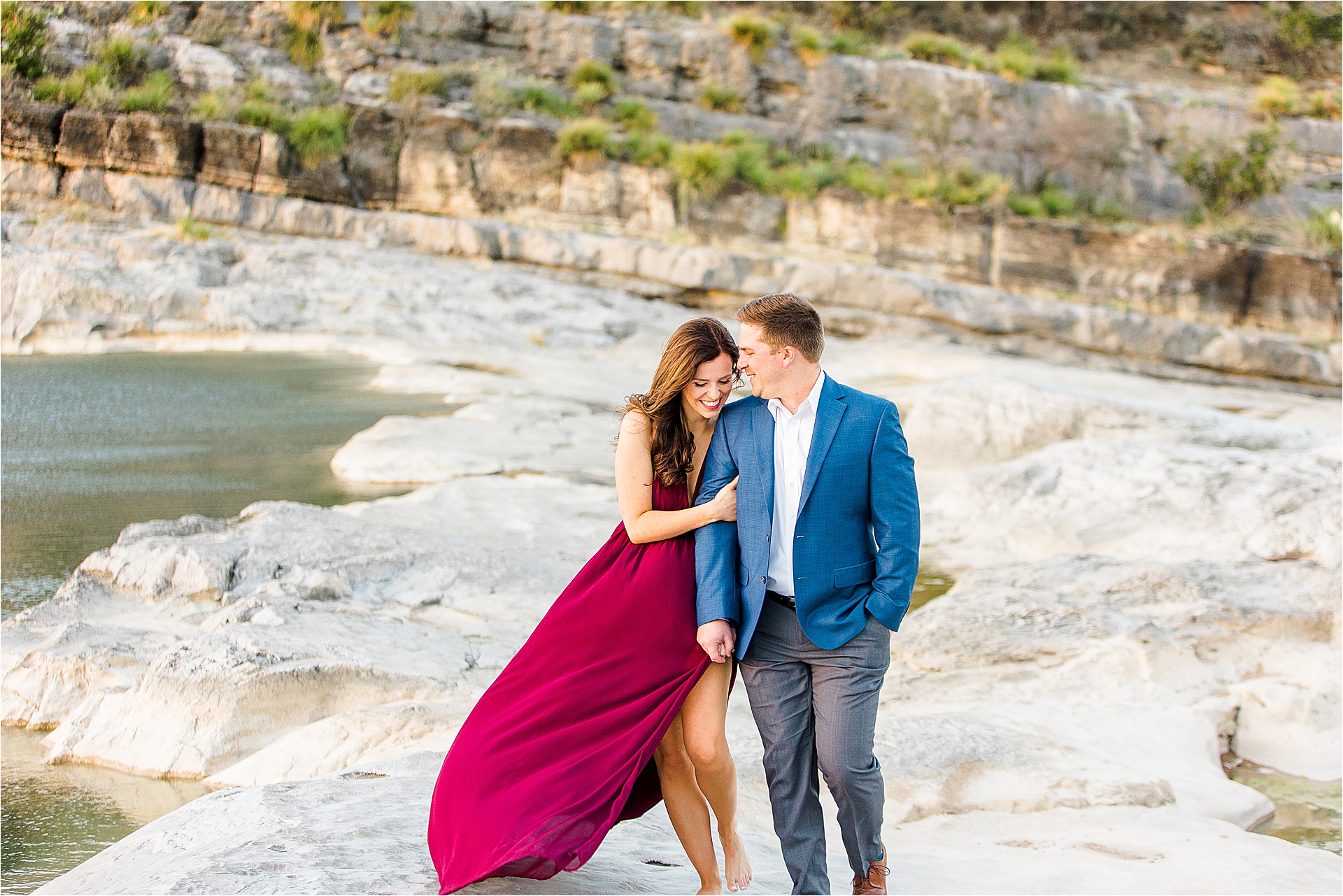 A couple snuggles close as the sun sets along the water at Pedernales Falls State Park near Austin, Texas. 