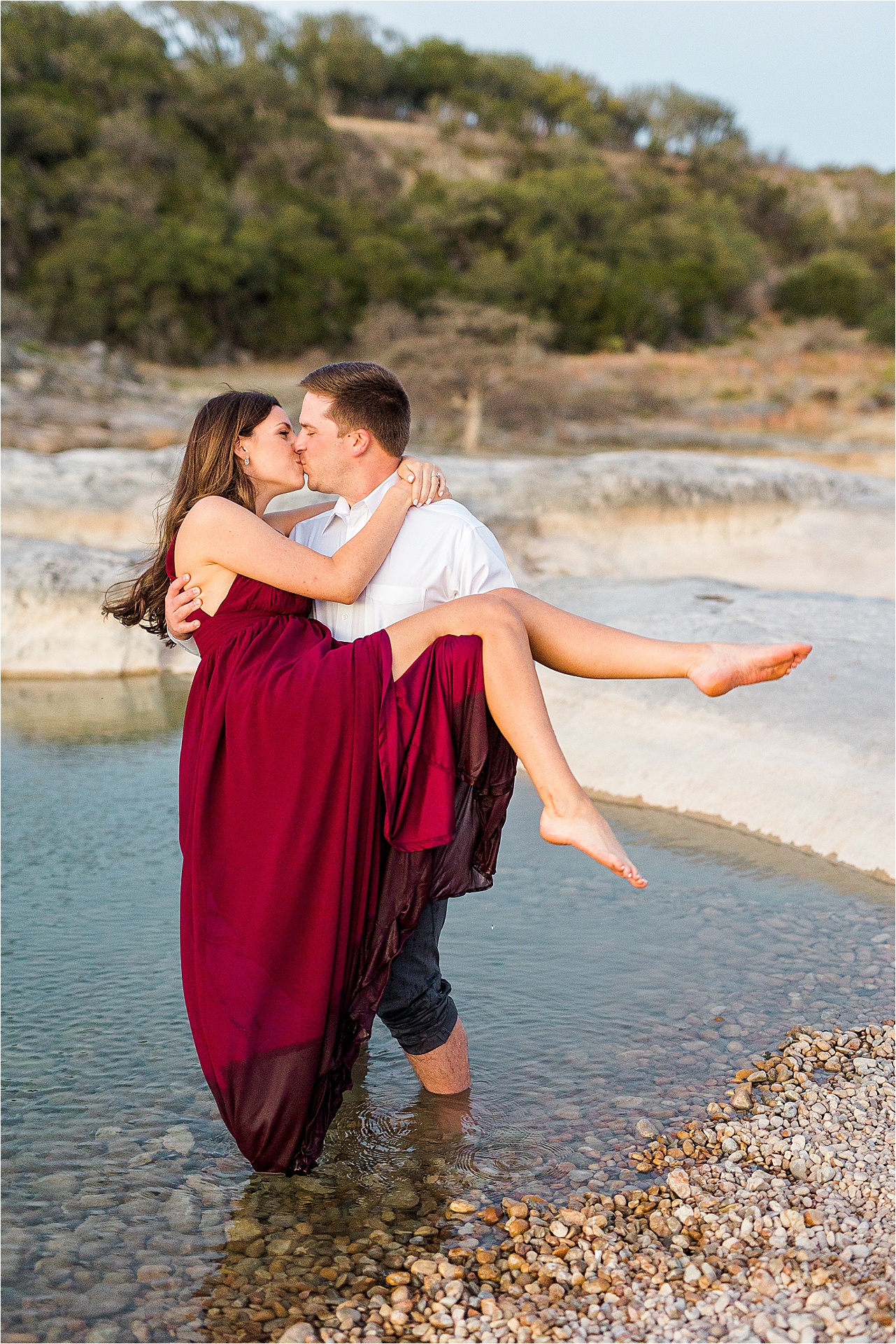 A couple kisses in the water at Pedernales Falls State Park during their Austin Texas Engagement Session 
